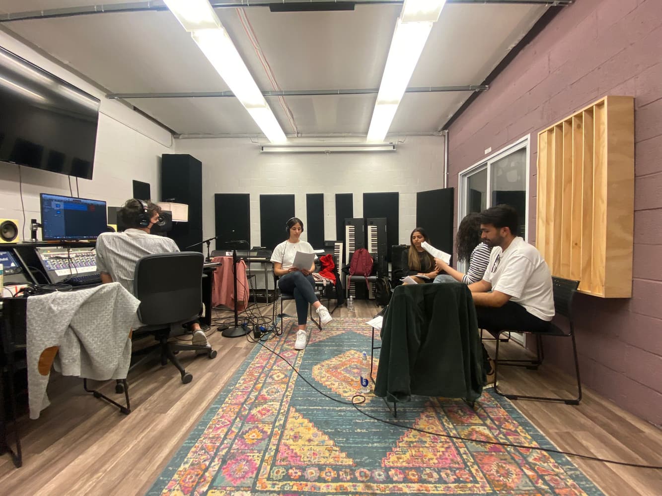 Student hosts and producers in the recording booth